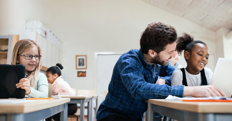 Un maître d'école aidant ses élèves