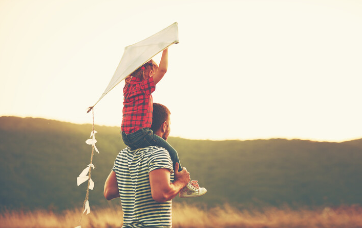 Un père qui porte son enfant sur ses épaules - Démarches AXA déshérence